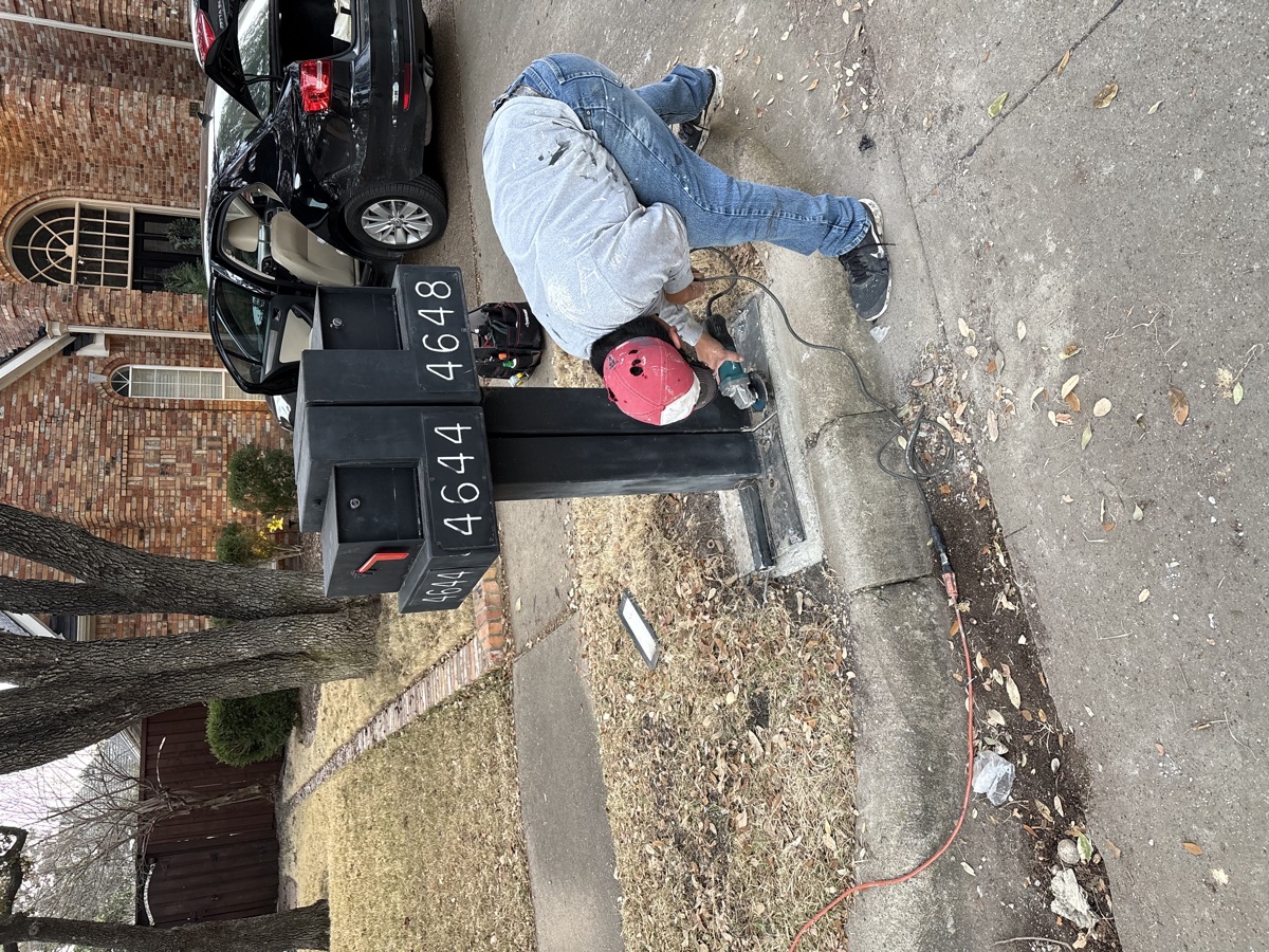 Volunteer repairing Deerfield mailboxes on a neighborhood street