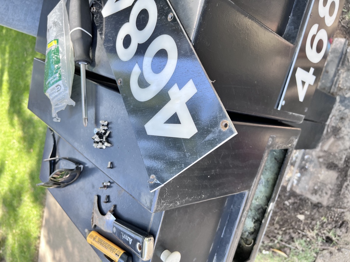 Mailbox repair work in progress with tools and panels